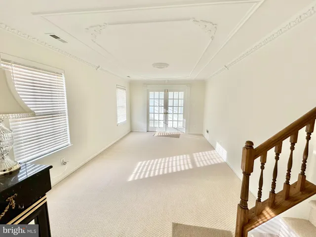 a view of empty room with wooden floor and windows