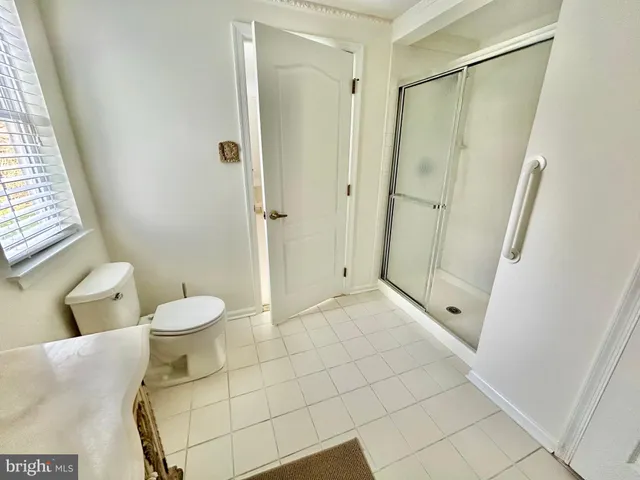 a bathroom with a toilet and shower