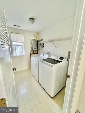 a utility room with cabinets washer and dryer