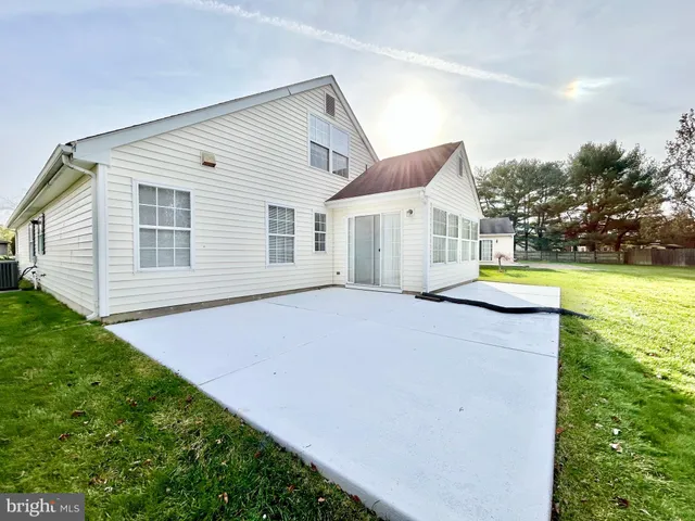 a front view of a house with a garden and yard