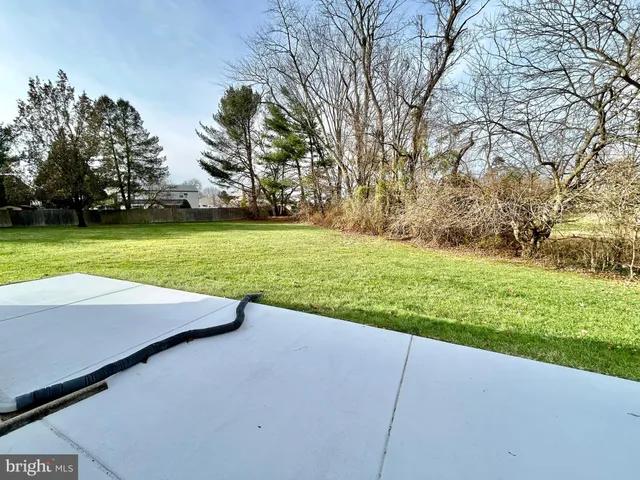 a view of a white house with a yard