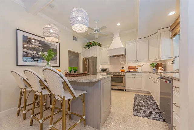 a kitchen with cabinets a sink a counter space and stainless steel appliances