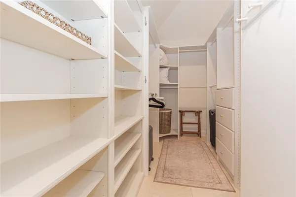 a bedroom with a bed a dresser and next to a window