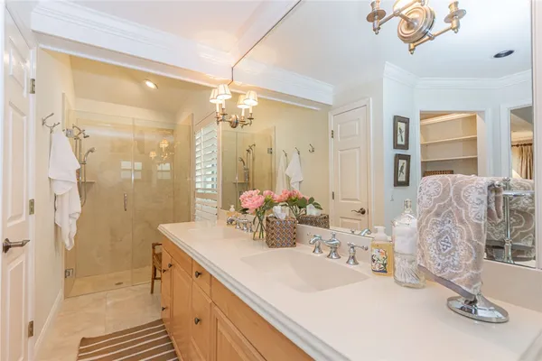 a bathroom with a sink a vanity and a shower curtain