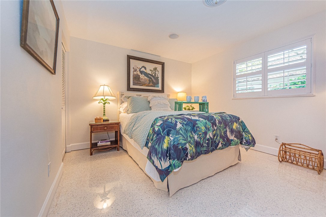 910 Seagrape Lane Vero Beach, FL 32963 - Photo 22 of 36 a bedroom with a bed lamp and a window