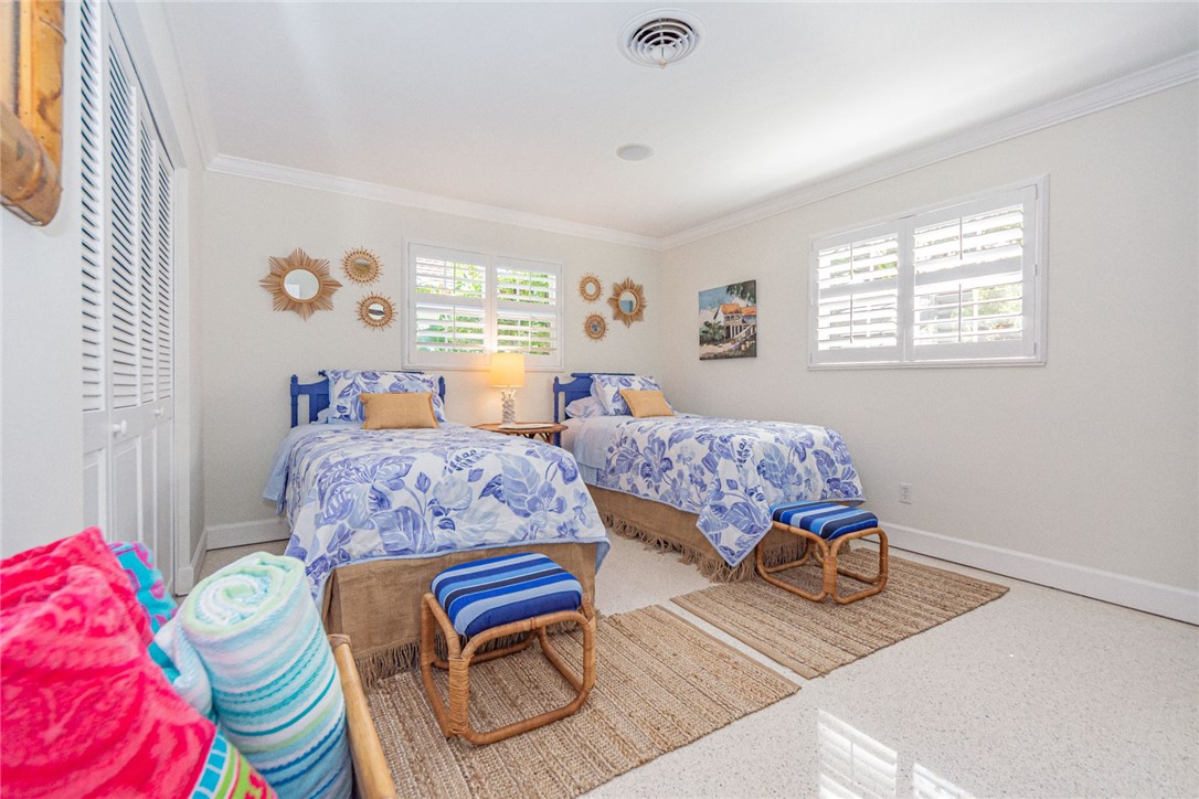 910 Seagrape Lane Vero Beach, FL 32963 - Photo 25 of 36 a bedroom with two beds and a window