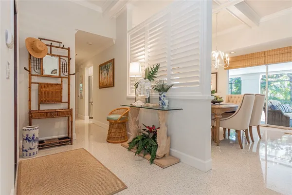 a living room with furniture a potted plant and a large window