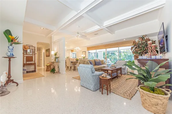 a living room with patio furniture and a potted plant
