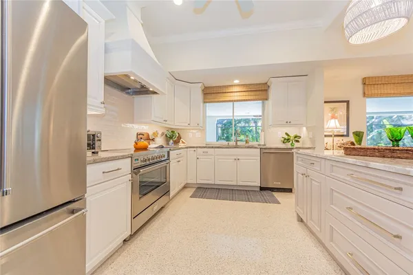 a kitchen with white cabinets and white appliances