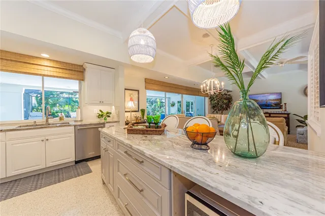 a kitchen with stainless steel appliances granite countertop a sink a counter space and wooden floor