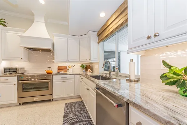 a kitchen with cabinets a sink a counter space and stainless steel appliances