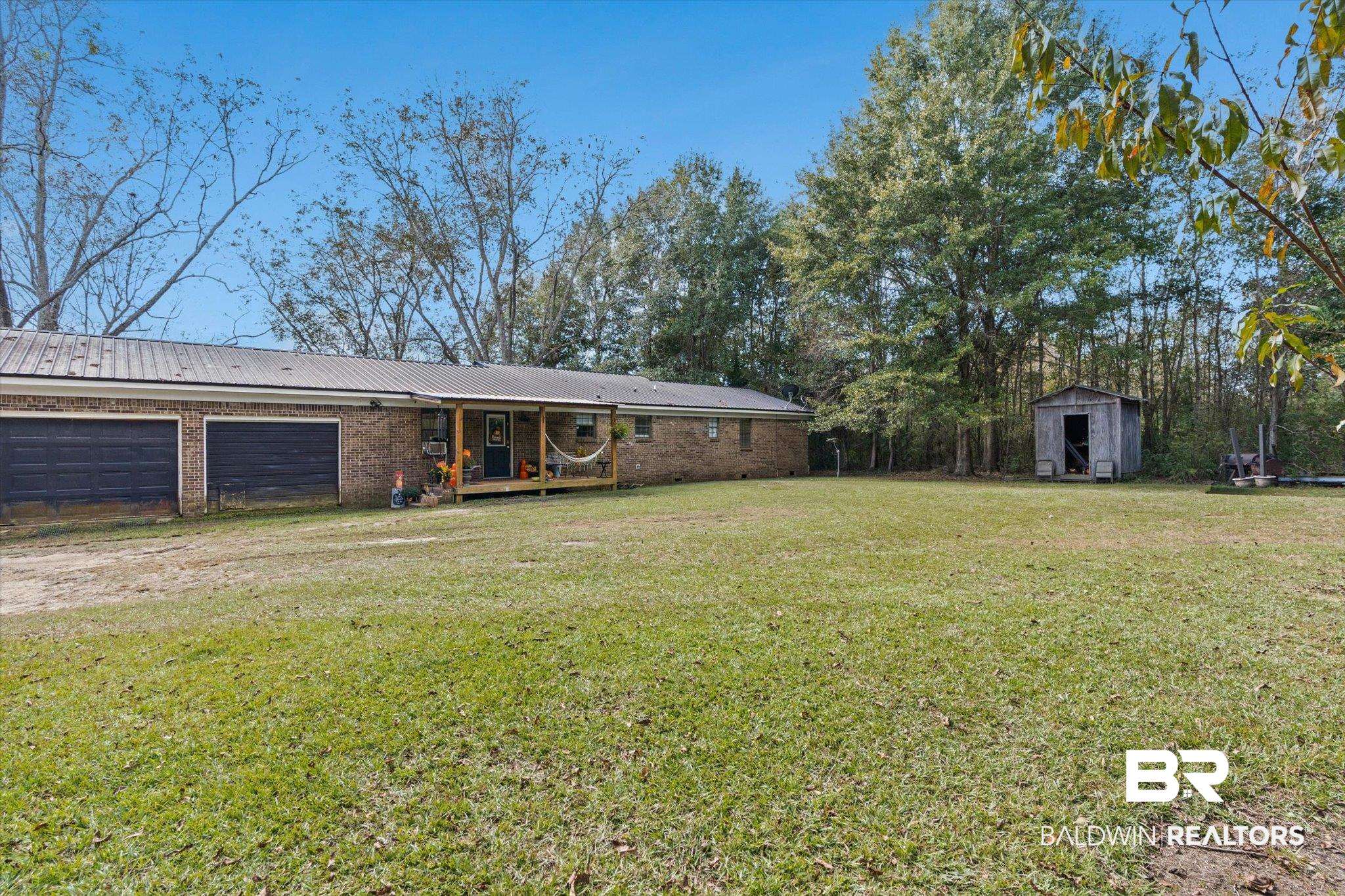 11440 Diffee Road Grand Bay, AL 36541 - Photo 20 of 22 Single story home with a garage, a front yard, a porch, brick siding, and a metal roof