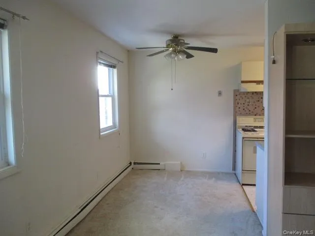 an empty room with windows and closet