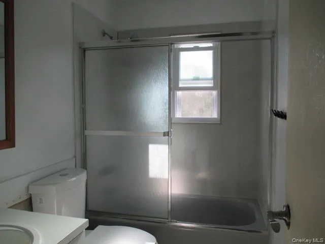 a bathroom with a toilet and a shower