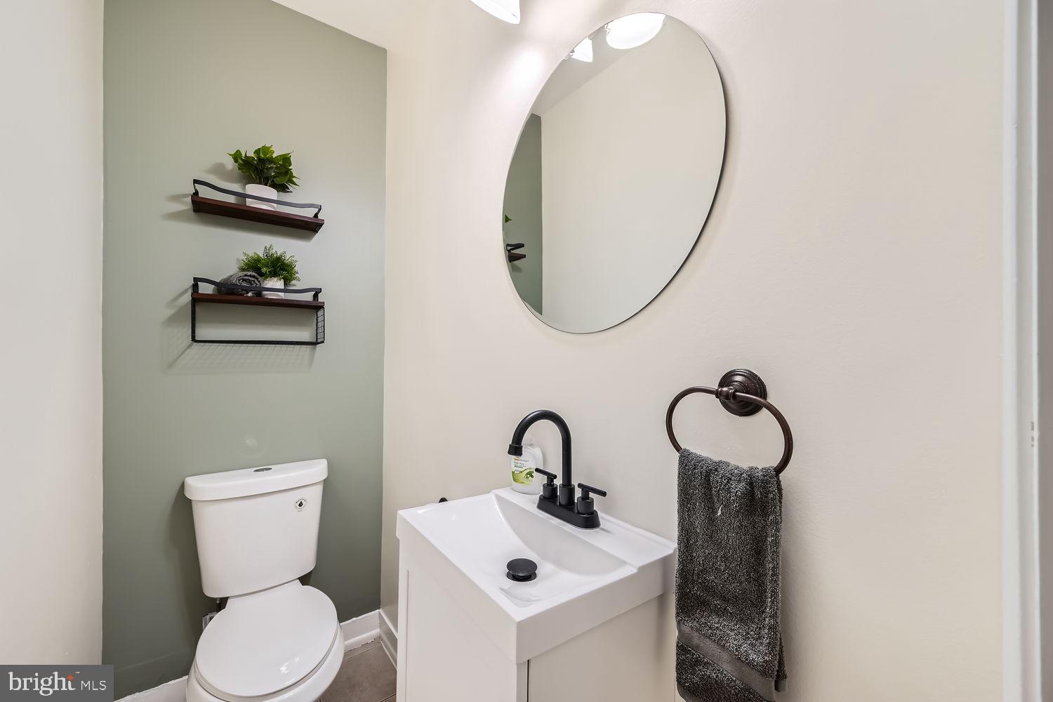 2415 Hammonds Ferry Road Halethorpe, MD 21227 - Photo 7 of 26 a bathroom with a toilet sink and mirror