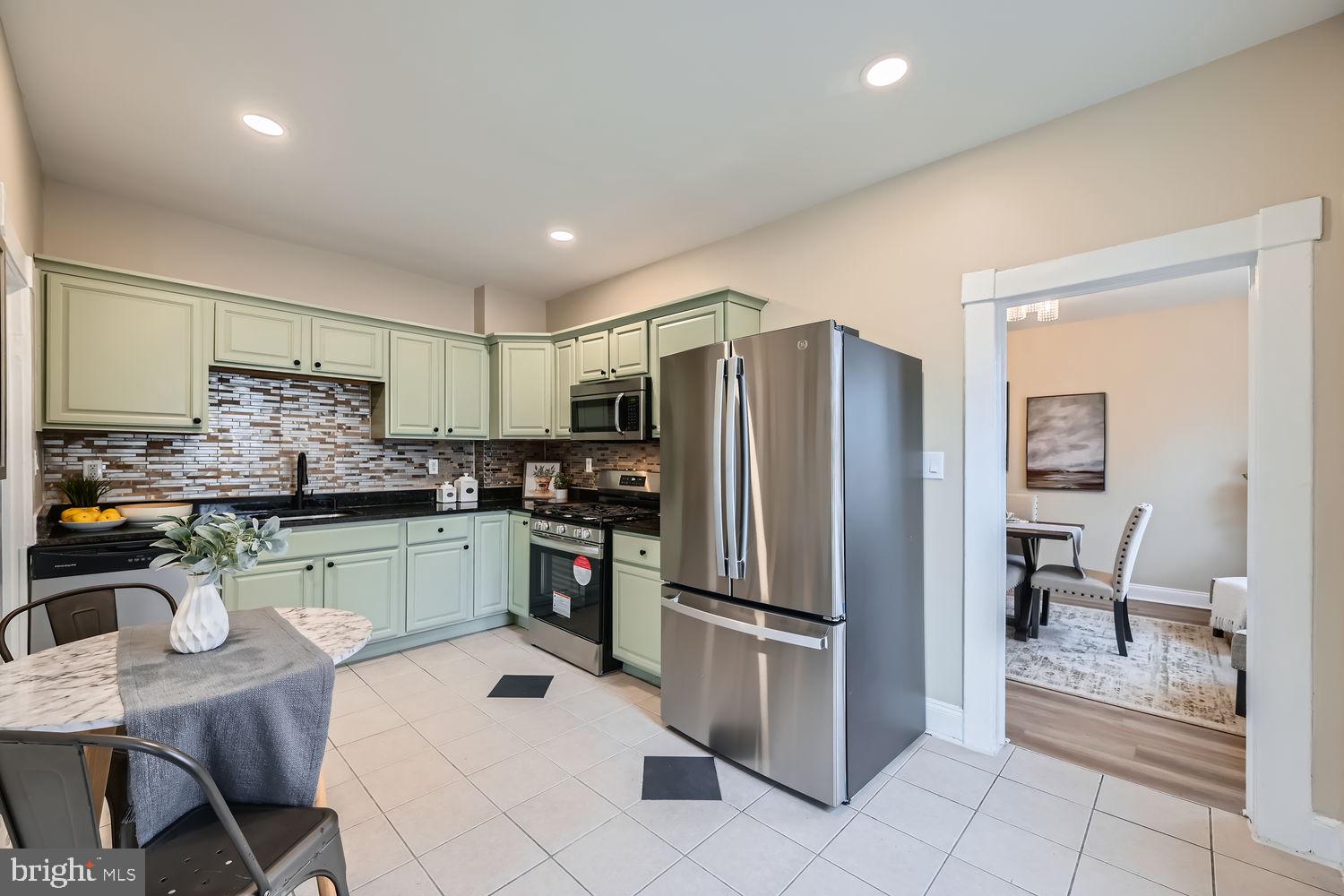 2415 Hammonds Ferry Road Halethorpe, MD 21227 - Photo 8 of 26 a kitchen with stainless steel appliances granite countertop a refrigerator and a stove top oven