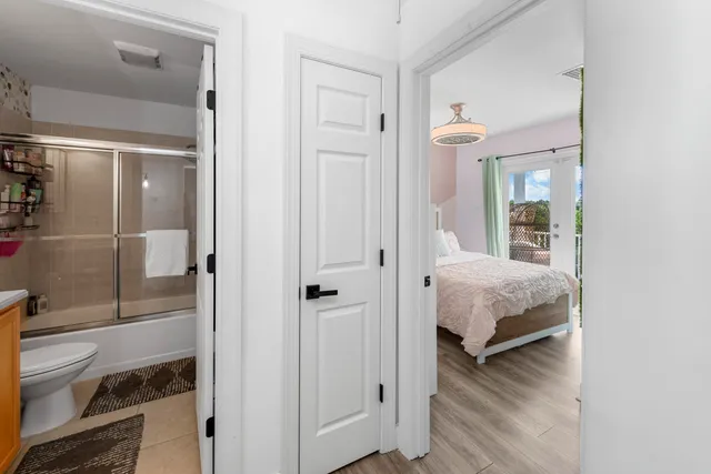 a living room with a bed and a walk in closet