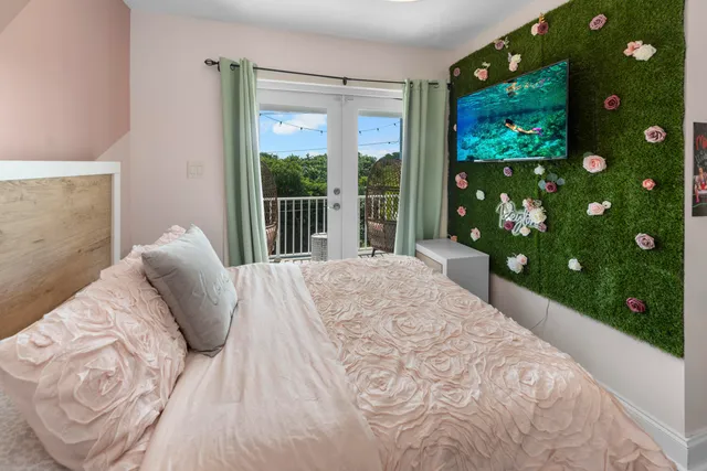 a bed sitting in a bedroom next to a window