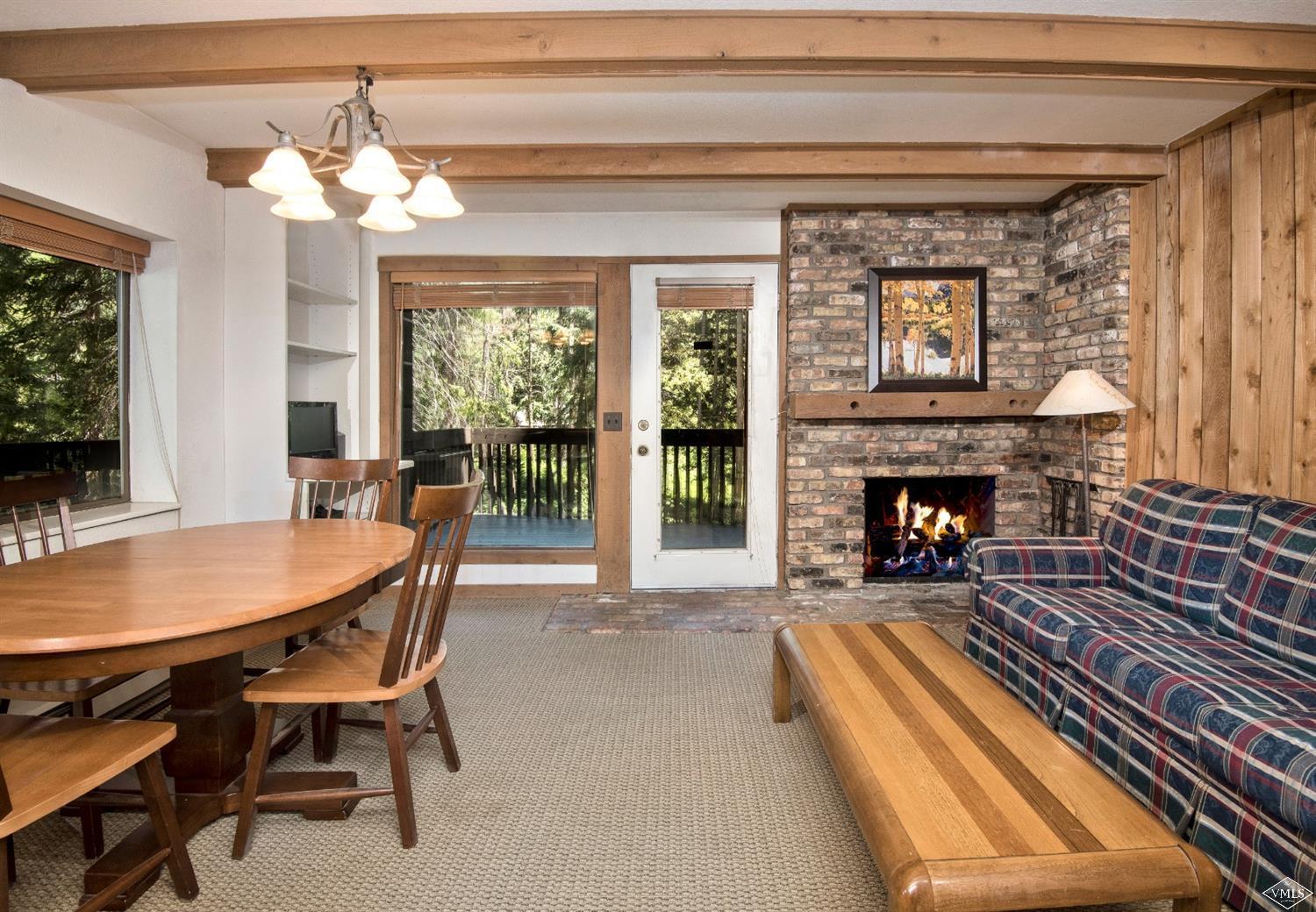 4570 Vail Racquet Club Drive, Unit 21 Vail, CO 81657 - Photo 2 of 16 a dining room with furniture and a fireplace
