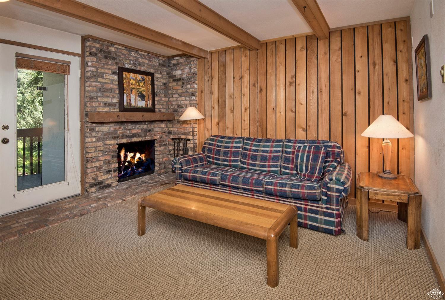 4570 Vail Racquet Club Drive, Unit 21 Vail, CO 81657 - Photo 4 of 16 a living room with furniture and a fireplace