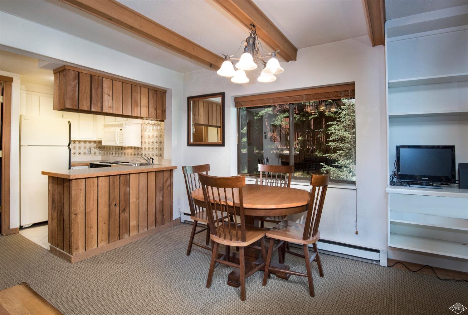 4570 Vail Racquet Club Drive, Unit 21 Vail, CO 81657 - Photo 6 of 16 a view of a dining room with furniture window and wooden floor