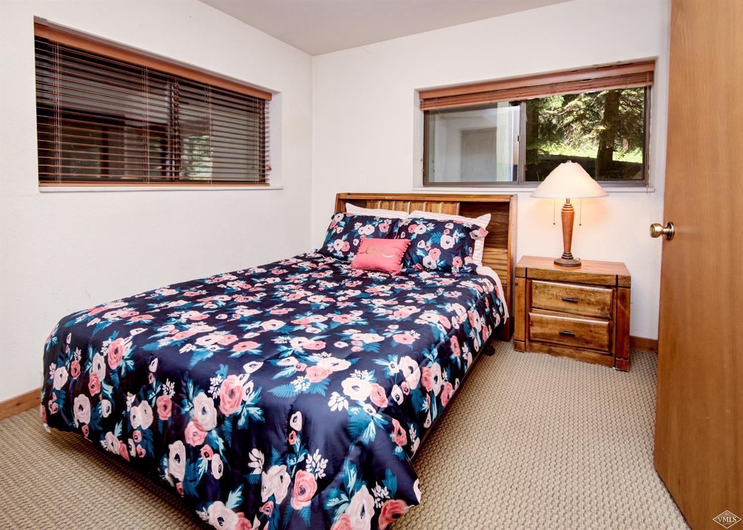 4570 Vail Racquet Club Drive, Unit 21 Vail, CO 81657 - Photo 10 of 16 a bedroom with a bed window and dresser