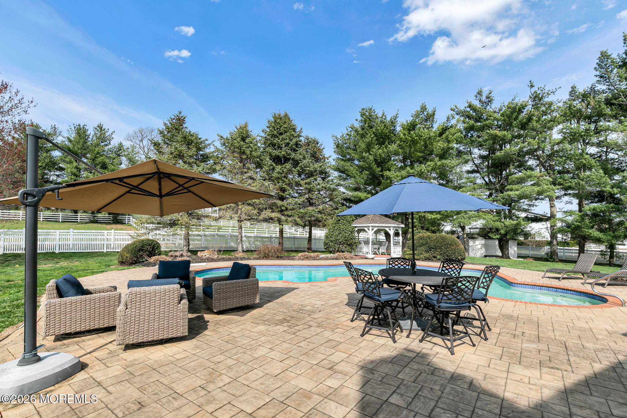 10 Paddock Lane Colts Neck, NJ 07722 - Photo 21 of 55 an outdoor space with patio lots of furniture and umbrella