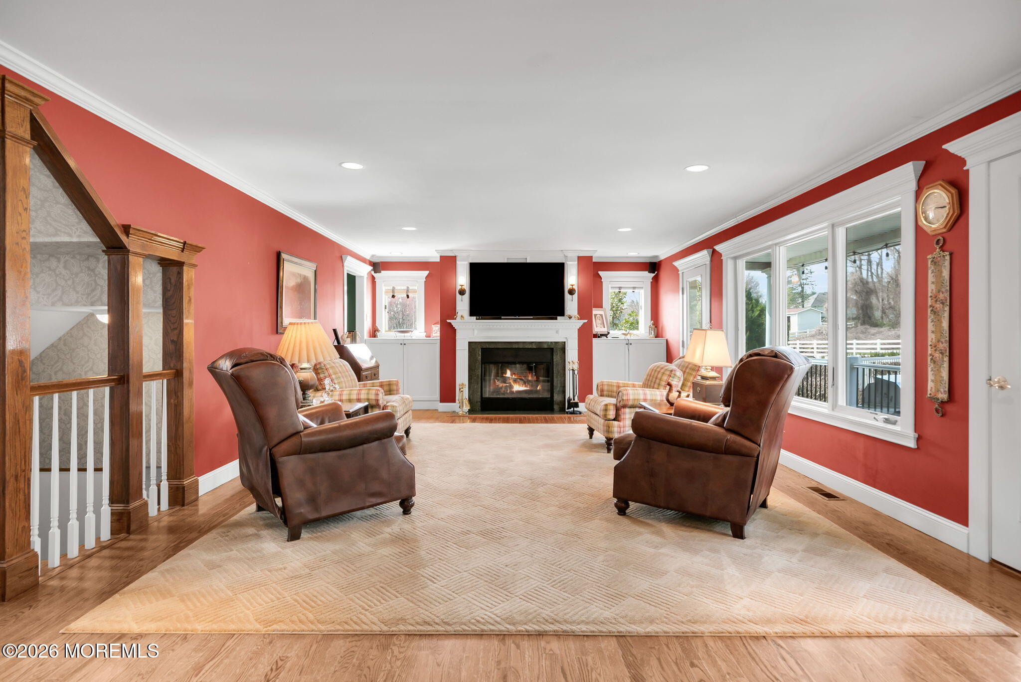 10 Paddock Lane Colts Neck, NJ 07722 - Photo 28 of 55 a living room with furniture a large window and a fireplace