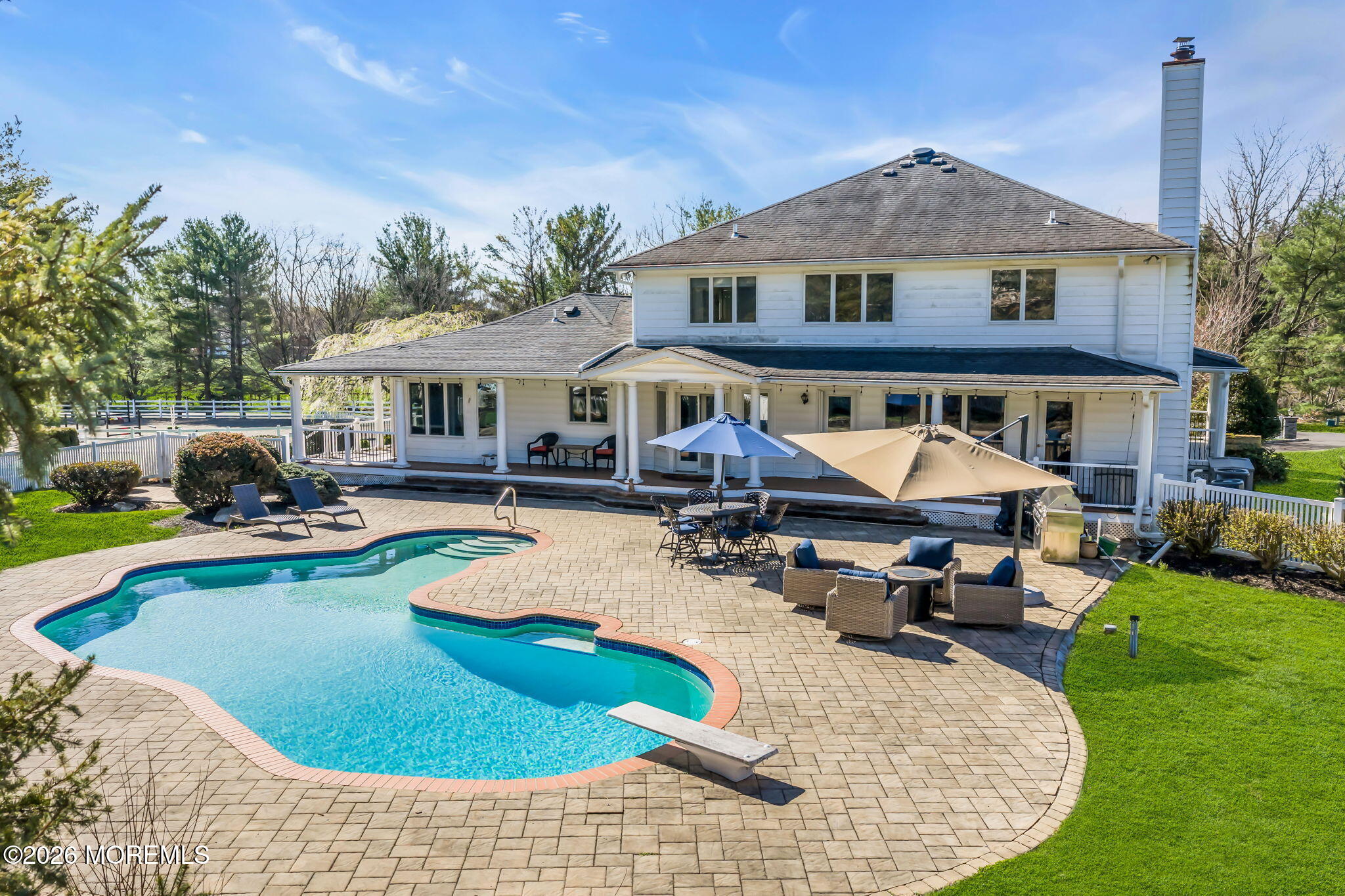 10 Paddock Lane Colts Neck, NJ 07722 - Photo 3 of 55 a view of a house with swimming pool and sitting area