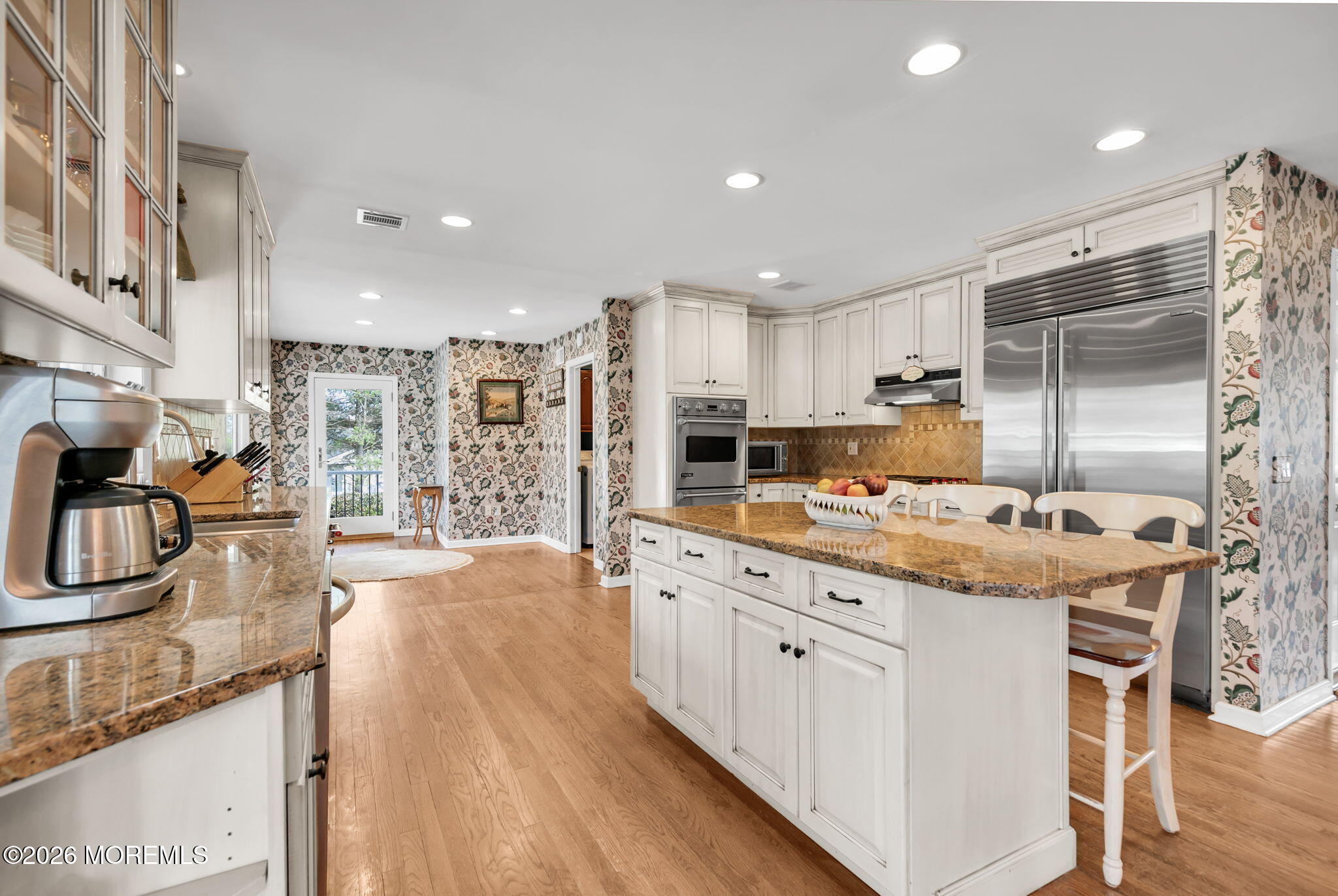 10 Paddock Lane Colts Neck, NJ 07722 - Photo 36 of 55 a kitchen with stainless steel appliances granite countertop a stove oven and a refrigerator with white cabinets