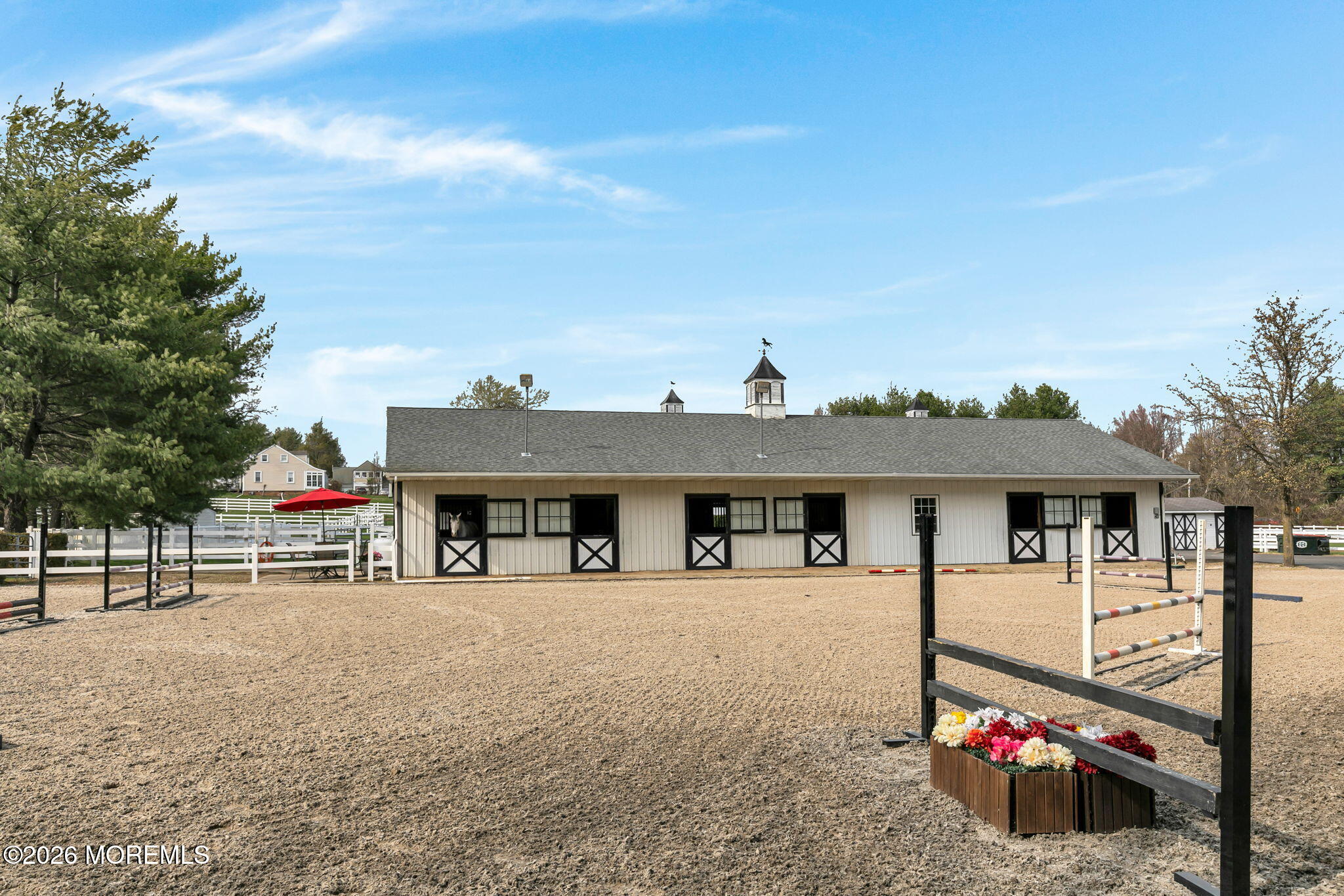 10 Paddock Lane Colts Neck, NJ 07722 - Photo 52 of 55 a view of a house with floor to ceiling windows and a table
