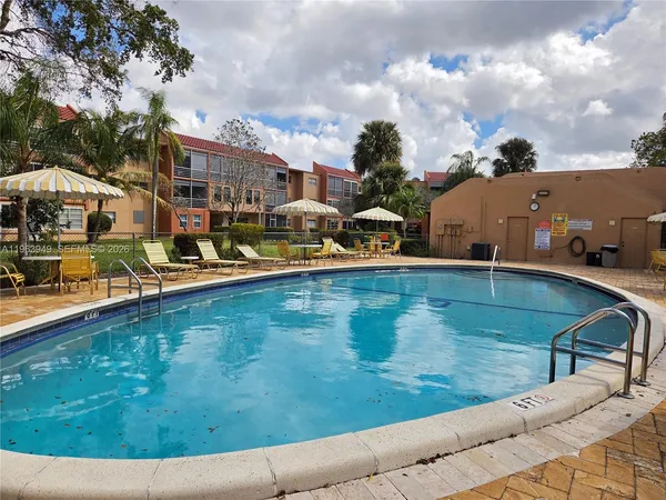 a view of a swimming pool with an outdoor seating