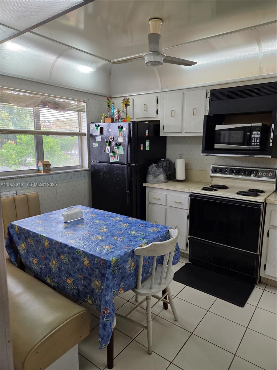 8834 West McNab Road, Unit 201 Tamarac, FL 33321 - Photo 2 of 27 a kitchen with a stove a sink and a refrigerator