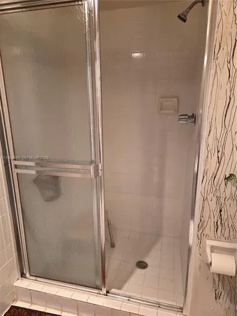 a bathroom with a glass shower door