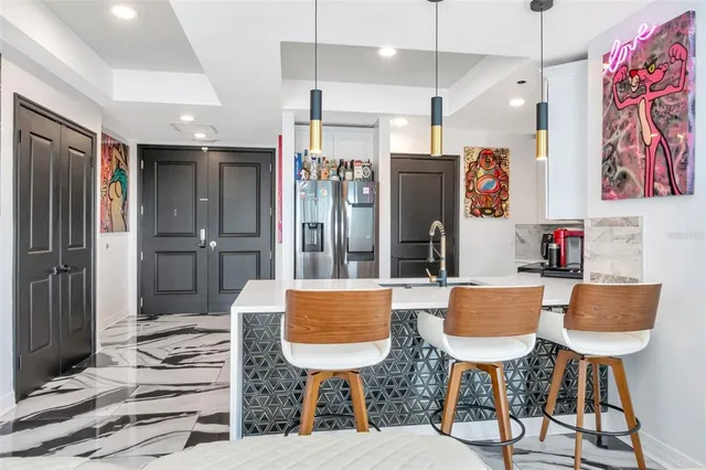 a work room with furniture and floor to ceiling windows