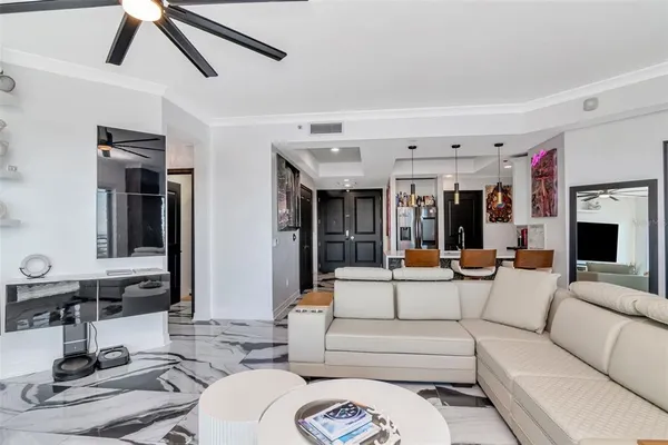 a living room with a large window and furniture