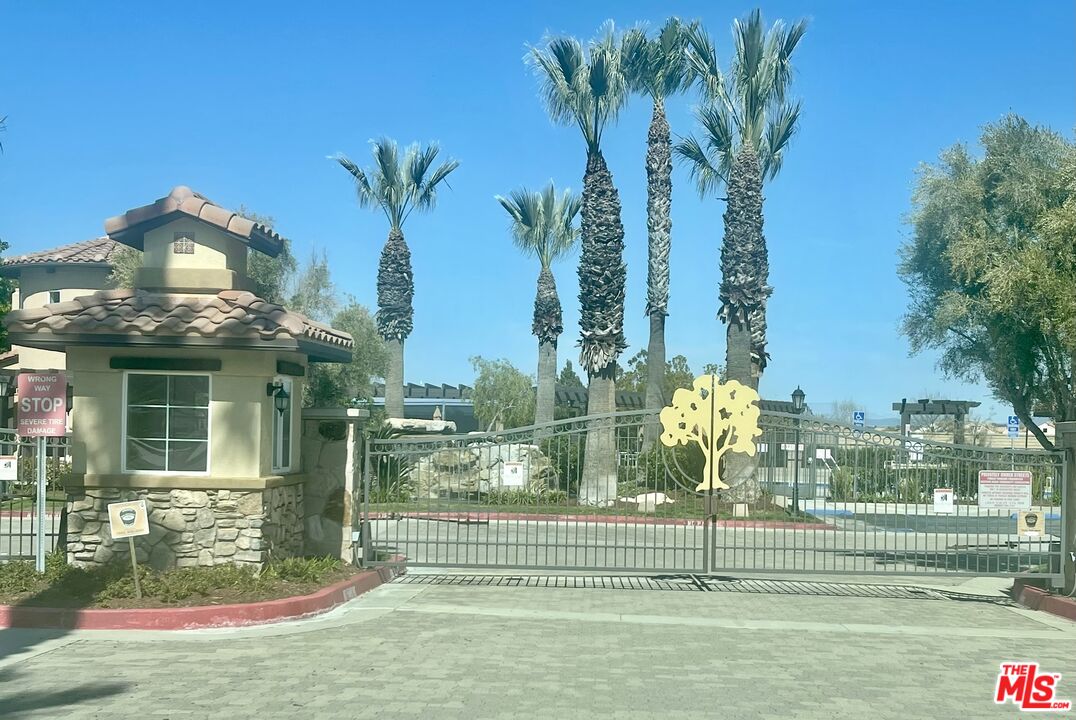 17983 Lost Canyon Road, Unit 116 Canyon Country, CA 91387 - Photo 3 of 11 a view of a house and a yard with a fountain