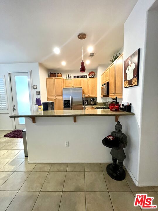 17983 Lost Canyon Road, Unit 116 Canyon Country, CA 91387 - Photo 6 of 11 a kitchen with stainless steel appliances kitchen island granite countertop a sink and cabinets