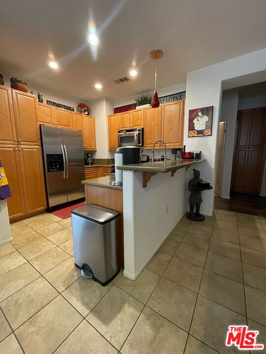 17983 Lost Canyon Road, Unit 116 Canyon Country, CA 91387 - Photo 7 of 11 a kitchen with a sink a counter top space cabinets and stainless steel appliances