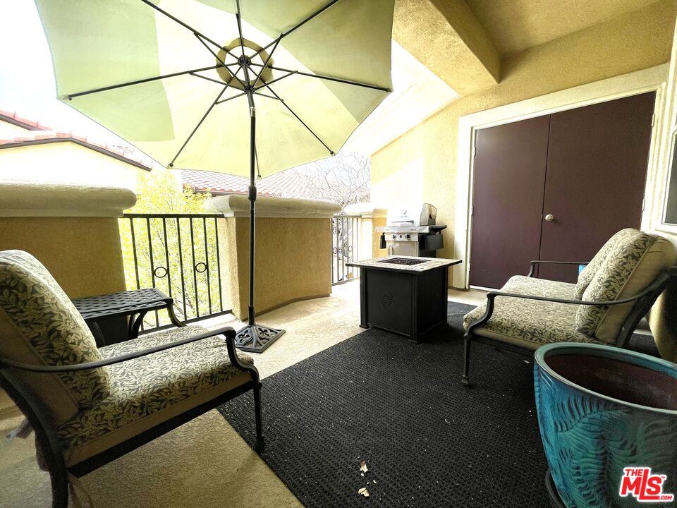 17983 Lost Canyon Road, Unit 116 Canyon Country, CA 91387 - Photo 9 of 11 a living room with furniture a ceiling fan and a rug
