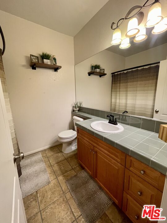 17983 Lost Canyon Road, Unit 116 Canyon Country, CA 91387 - Photo 10 of 11 a bathroom with a double vanity sink and mirror