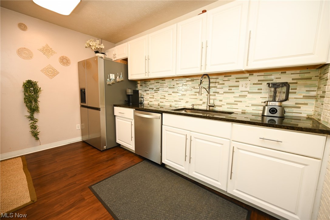 5651 Broadview Road, Unit C9 Cleveland, OH 44134 - Photo 8 of 29 Kitchen with white cabinetry, dark wood-type flooring, stainless steel appliances, and sink