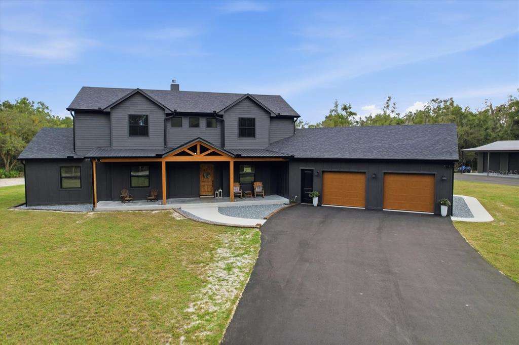 a front view of a house with a yard and a garage