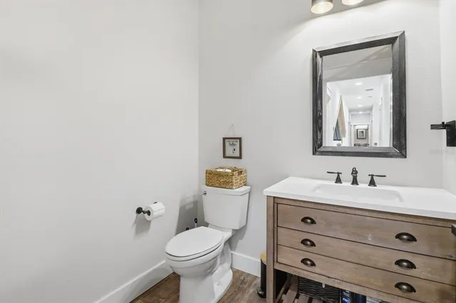 an aerial view of a house with a yard and large trees