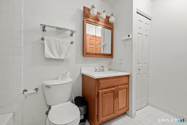 a bathroom with a toilet sink and mirror