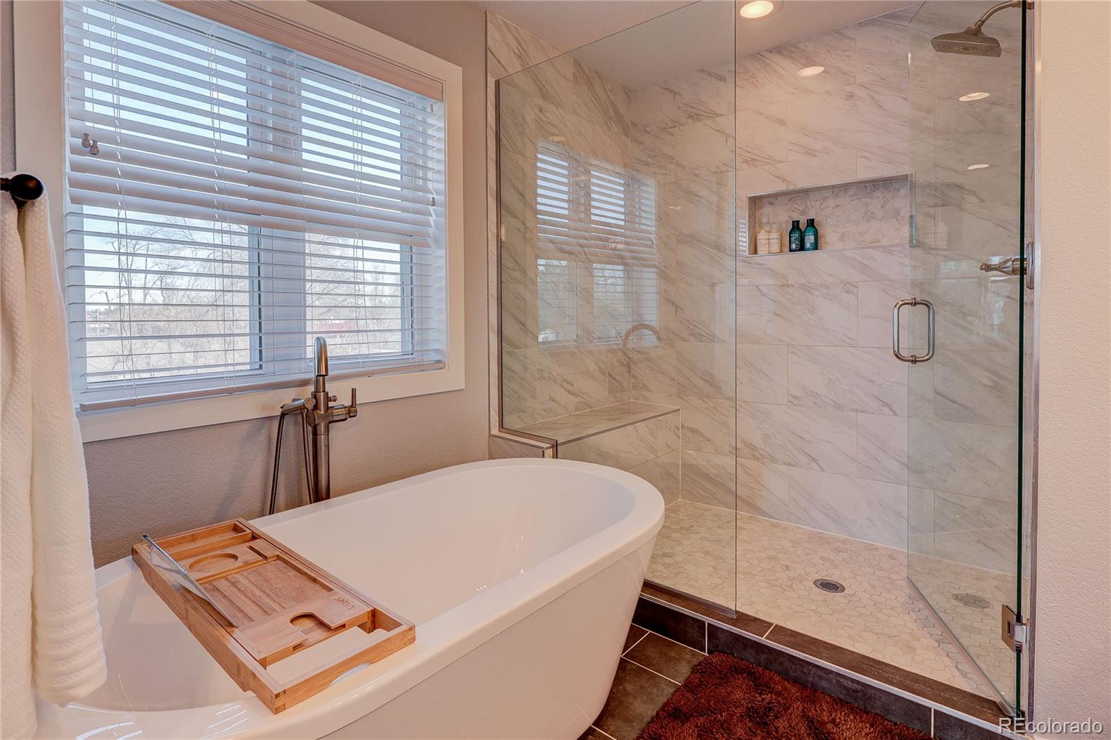 4792 South Acoma Street Englewood, CO 80110 - Photo 11 of 19 a bathroom with a tub shower and sink