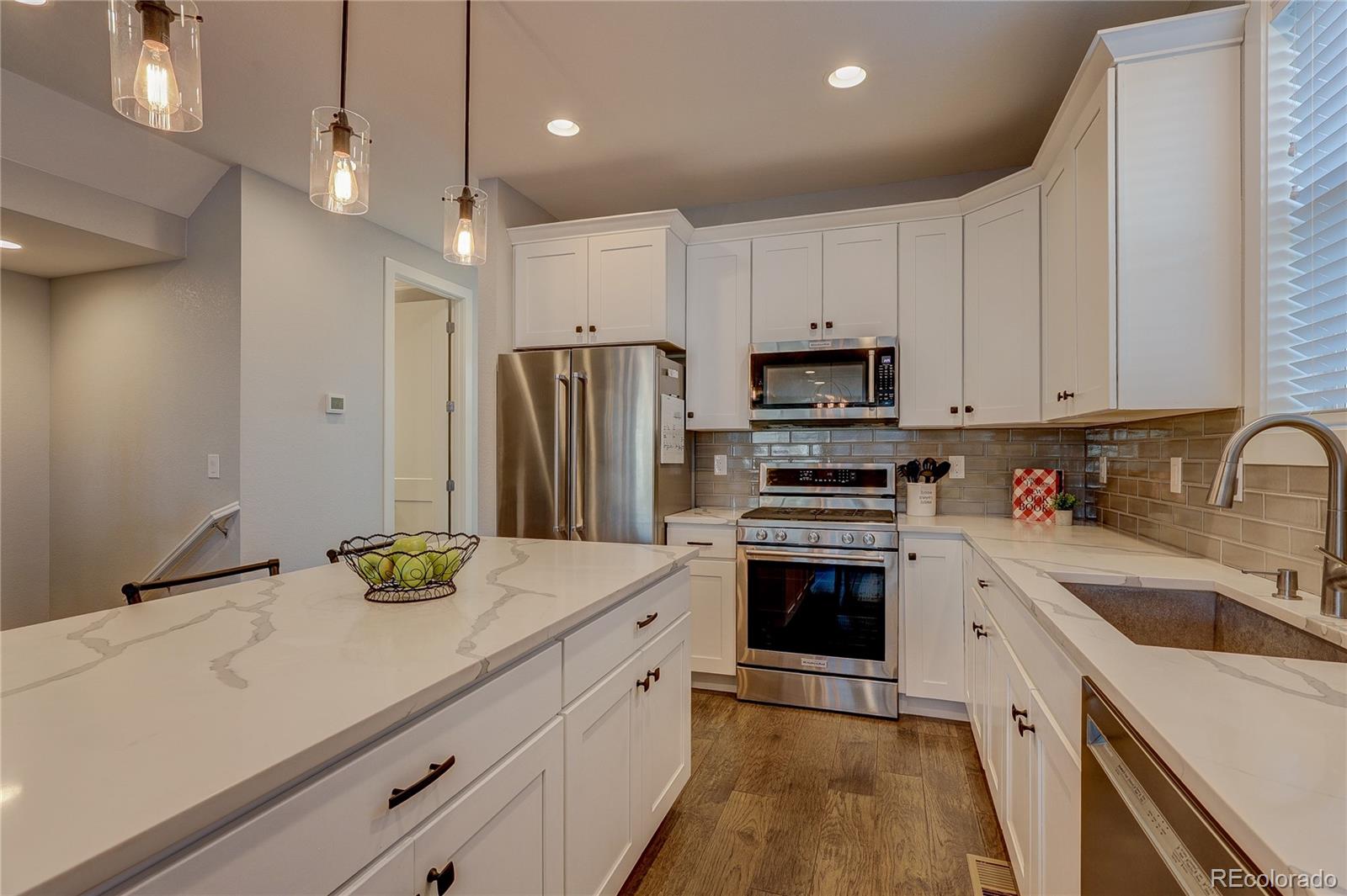 4792 South Acoma Street Englewood, CO 80110 - Photo 3 of 19 a kitchen with a sink appliances and cabinets