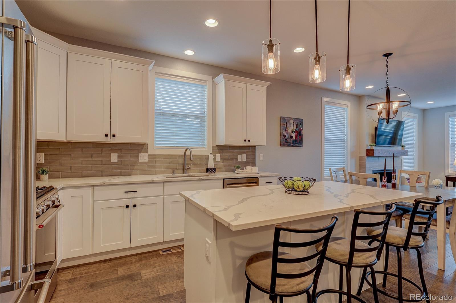 4792 South Acoma Street Englewood, CO 80110 - Photo 4 of 19 a kitchen with a sink dining table and chairs