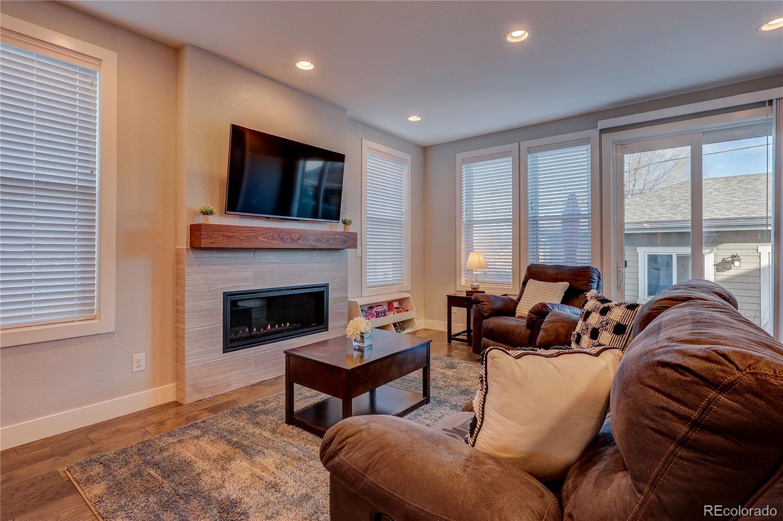 4792 South Acoma Street Englewood, CO 80110 - Photo 6 of 19 a living room with furniture and a fireplace