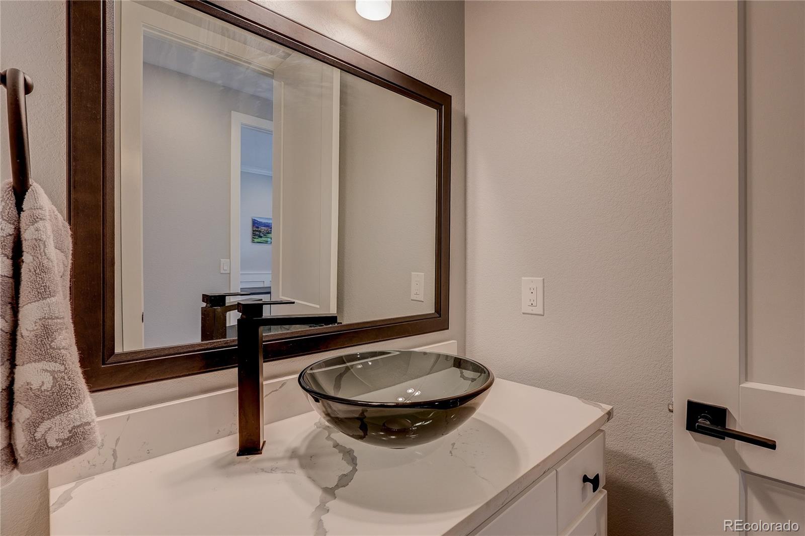 4792 South Acoma Street Englewood, CO 80110 - Photo 8 of 19 a bathroom with a sink and a mirror